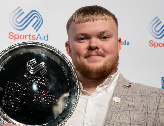 Mark holding winners trophy