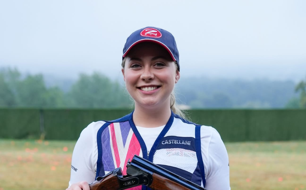 Bethany holding her gun in a safe open position